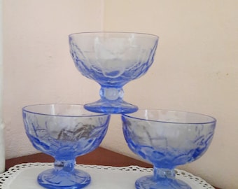 Vintage ice cream bowls. Three blue glass ice cream cups. Dessert glass on a pedestal. Dessert bowls. Blue old fashioned ice cream bowl