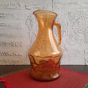 Retro glass jug, water carafe, wine jug. Retro glass jug in amber color. Wine jug, water jug. Jug for cold drinks.