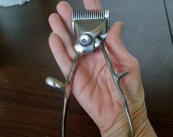 Retro hand clipper. Barbershop decor. Old beard clipper, manual beard trimmer.