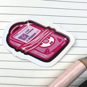 May include: A pink sticker of a retro music player with a screen displaying a song title. The sticker has a white border and is decorated with musical notes and sparkles. The text "New Playing" is visible on the screen.