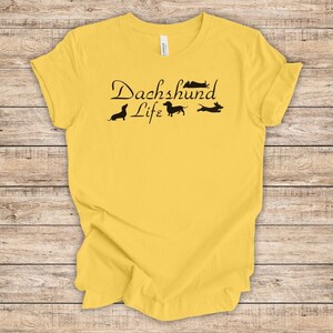 May include: Yellow t-shirt with the text "Dachshund Life" and four dachshund silhouettes.