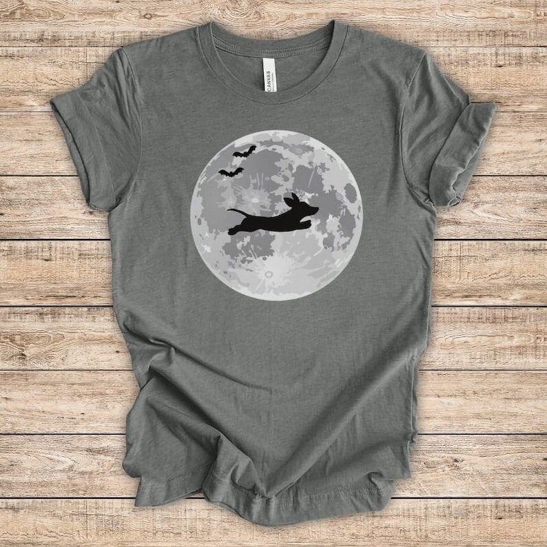 May include: A dark gray t-shirt with a silhouette of a dachshund jumping in front of a full moon with bats flying overhead.