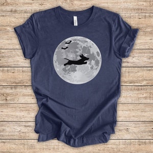 May include: A navy blue t-shirt with a silhouette of a dachshund jumping in front of a full moon with bats flying above.