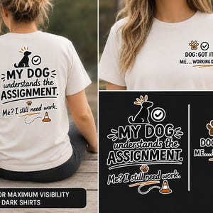 May include: A cream-colored t-shirt featuring a graphic on the back that reads, "MY DOG understands the ASSIGNMENT. Me? I still need work." with a dog icon, a checkmark, and a traffic cone. The front chest area displays, "DOG: GOT IT. ME... WORKING ON IT."