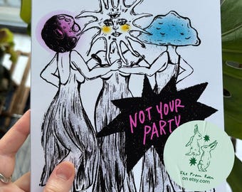 May include: A white rectangular card featuring a black ink illustration of three figures in long dresses. The figures have a moon, a sun with three eyes, and a blue mushroom for heads. A black starburst shape contains the pink text NOT YOUR PARTY.