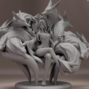 May include: A grey sculpture of a woman seated on a throne, surrounded by nine fox tails. The woman wears a crown and a detailed gown. The throne is adorned with intricate details, and the fox tails are arranged around the figure.