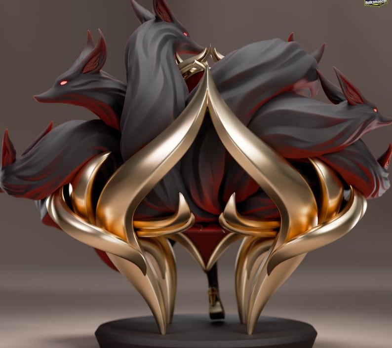 May include: A detailed figurine featuring a stylized design of a creature with multiple fox-like heads and tails. The sculpture has a dark color scheme with gold accents. The fox heads have red eyes. The base is black.