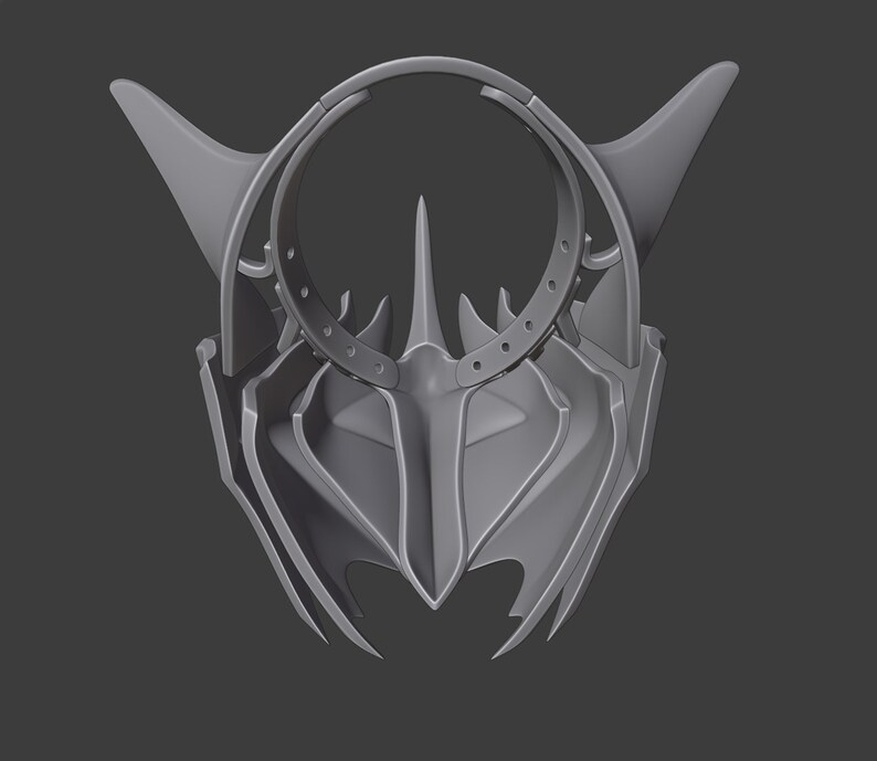 Puede incluir: Una m&aacute;scara gris impresa en 3D con un dise&ntilde;o afilado y angular. La m&aacute;scara tiene un c&iacute;rculo grande abierto en el centro y una forma triangular puntiaguda en la parte inferior.