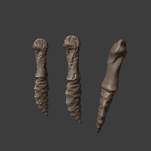 May include: Three different styles of brown, textured, ceramic, dagger-shaped, decorative objects.