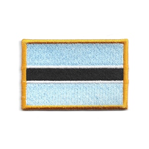 May include: Embroidered patch depicting the flag of Botswana. The rectangular patch has a light blue background with a black stripe in the centre, bordered by a white stripe. The patch is outlined with a gold border.