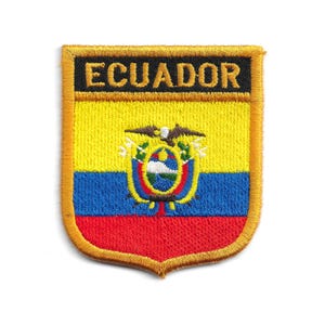 May include: Embroidered patch featuring the word "ECUADOR" in gold lettering on a black background. The patch displays the Ecuadorian flag's colors: yellow, blue, and red, with the national emblem in the center. The patch has a gold border.