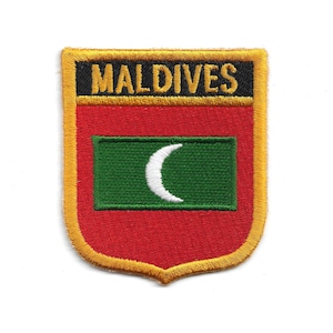 May include: Embroidered patch with the word "MALDIVES" in black on a gold border. The patch has a red background with a green rectangle containing a white crescent moon, resembling the Maldives flag.