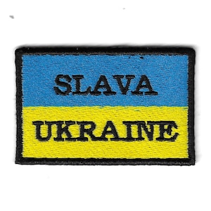 May include: A blue and yellow embroidered patch with the words "SLAVA UKRAINE" in black.