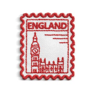 May include: A rectangular embroidered patch with a scalloped red border on a white background. The design features red stitching of the word ENGLAND at the top, with a detailed depiction of Big Ben and the Houses of Parliament below it.