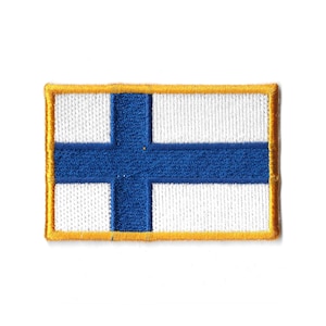 May include: Embroidered patch featuring the flag of Finland. The design includes a blue Nordic cross on a white background, with a gold border. The patch is rectangular and likely for application on clothing or accessories.
