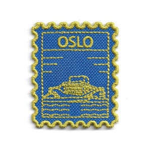 May include: Embroidered patch in the shape of a postage stamp. The patch features a blue background with the word "OSLO" in yellow thread. A yellow embroidered image of a building and water is below the text. The patch has a yellow scalloped border.