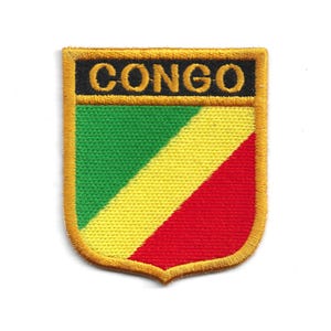 May include: Embroidered patch featuring the word "CONGO" in gold lettering on a black background. The patch has a shield shape with a green, yellow, and red diagonal stripe design, and a gold border.