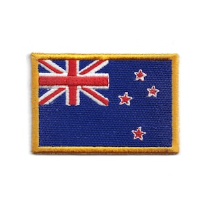 May include: A rectangular patch depicting the New Zealand flag. The flag has a blue background with the Union Jack in the top left corner, four red stars with white borders, and a gold border.