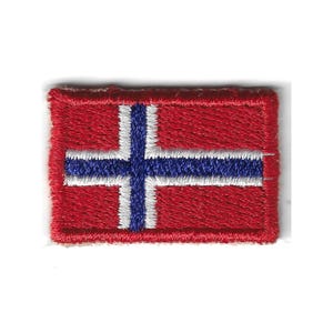 May include: A rectangular embroidered patch featuring the flag of Norway. The design consists of a red background with a blue Nordic cross outlined in white. The stitching is dense and uniform, creating a textured surface with a raised border.