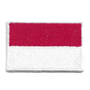 May include: A red and white fabric patch with the colors arranged in horizontal stripes. The patch has a white border.