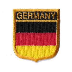 May include: A yellow, red, and black embroidered patch with the word "GERMANY" in gold lettering.