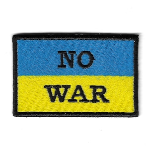 May include: A blue and yellow patch with the words "NO WAR" in black lettering.