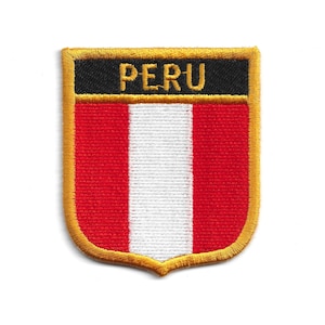 May include: Embroidered patch featuring the flag of Peru. The patch is shield-shaped with a gold border. The flag design includes vertical stripes of red, white, and red, with a black banner at the top that reads "PERU" in gold lettering.