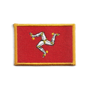 May include: Embroidered patch featuring the flag of the Isle of Man. The patch has a red background with a gold border. The emblem is a triskeles of three armored legs, with yellow spurs, arranged in a circle.