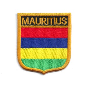 May include: Embroidered patch featuring the word "MAURITIUS" in black on a gold border. The patch displays horizontal stripes of red, blue, yellow, and green, resembling a flag. The patch has a shield shape.