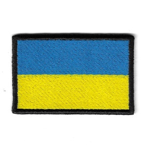 May include: A blue and yellow embroidered patch of the Ukrainian flag with a black border.