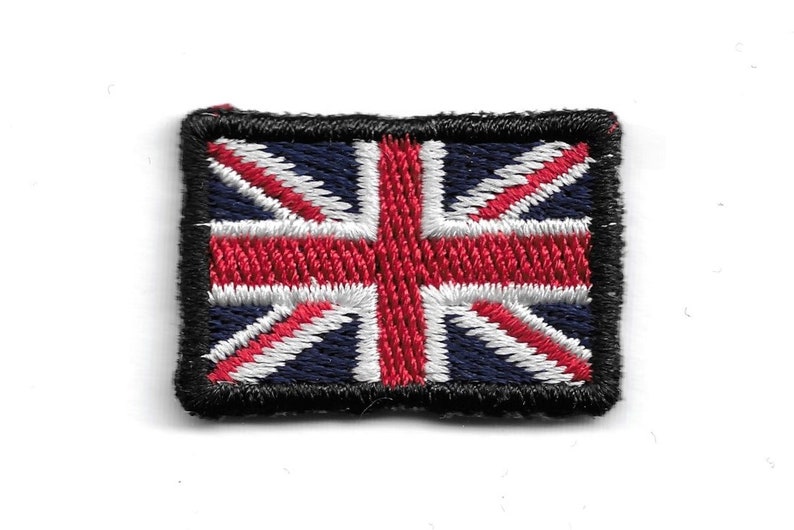 May include: Embroidered patch featuring the Union Jack, the national flag of the United Kingdom. The patch has a rectangular shape with a black border. The flag design includes red, white, and blue colors.