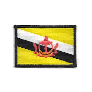 May include: Embroidered patch featuring the flag of Brunei. The design includes a yellow field, a white and black diagonal stripe, and a red emblem. The patch has a black border.