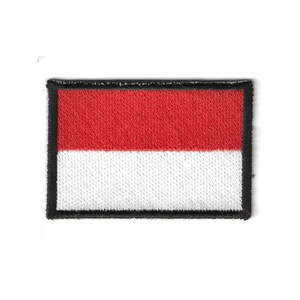 May include: Embroidered patch featuring the flag of Indonesia. The rectangular patch has a red upper half and a white lower half, with a black border. The patch is likely for clothing or accessories.
