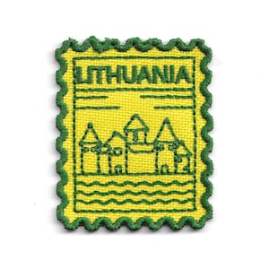 May include: A rectangular embroidered patch with a scalloped green border on a yellow background. The patch features the word LITHUANIA in green capital letters above a green stitched outline of a castle and wavy lines representing water.