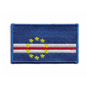 May include: A blue embroidered patch featuring the flag of Cape Verde. The flag has a red and white horizontal stripe with a circle of yellow stars in the centre.