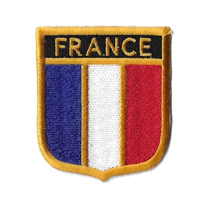 May include: A gold embroidered patch with the word "FRANCE" in black lettering and the French flag colors of blue, white, and red.