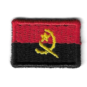 May include: A red, black, and yellow embroidered patch featuring the national flag of Angola. The flag has a red top half and a black bottom half with a yellow symbol of a rising sun with a star in the center.