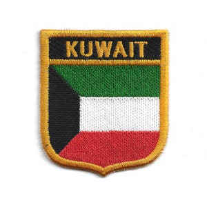 May include: Embroidered patch of the Kuwait flag in a shield shape. The patch has a gold border and the word "KUWAIT" in gold lettering at the top. The flag design features black, green, white, and red colours.