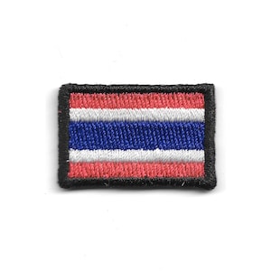 May include: Embroidered patch depicting the flag of Thailand. The rectangular patch features horizontal stripes in red, white, and blue, framed by a black border. The flag design is a symbol of national identity.