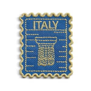 May include: A rectangular embroidered patch with a scalloped edge in tan thread. The patch features a blue background with the word ITALY stitched in tan at the top, above a tan embroidered graphic of a classical column with horizontal lines.
