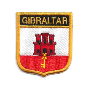 May include: A red, white, and gold embroidered patch with the word "GIBRALTAR" in black lettering. The patch features a red castle with a gold key.