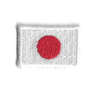 May include: A white embroidered patch with a red circle in the center, representing the flag of Japan.