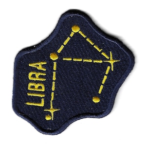 May include: A navy blue embroidered patch with the word "LIBRA" and a yellow constellation design.