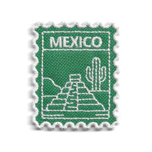 May include: Green fabric patch with white embroidered details. The patch features the word "MEXICO" at the top, and a pyramid and cactus design. The patch has a white, scalloped border.