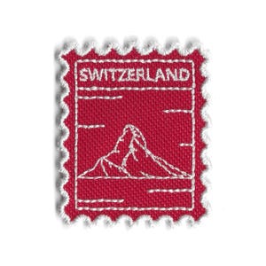 May include: A set of three ceramic mugs with a speckled, matte finish. Each mug features a different color: light blue, cream, and gray. The mugs have a simple, modern design and a comfortable handle.