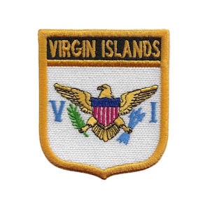 May include: Embroidered patch featuring the words "VIRGIN ISLANDS" in gold lettering above a detailed emblem. The emblem includes a golden eagle with outstretched wings, a shield with red and white stripes, and blue accents. The patch has a gold border.