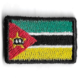 May include: An embroidered patch featuring the flag of Mozambique. The flag is red, green, black, and yellow with a white star in the center of the red triangle.