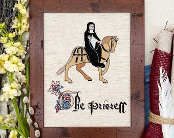 May include: A framed cross-stitch embroidery depicting a woman in a black habit riding a brown horse. The text "Be prudent" is below the image.