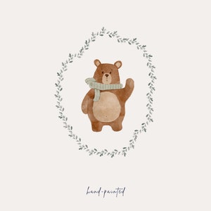 May include: A watercolor illustration of a brown bear wearing a light gray scarf, standing inside a wreath of green leaves. The text "hand-painted" is written below the bear.