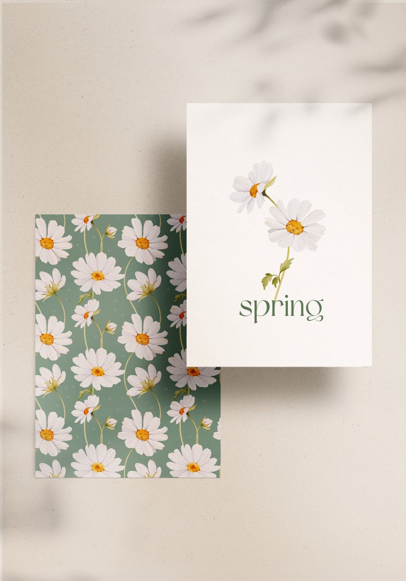 May include: A white card with a green background and the word "spring" printed in green. The card features a watercolor illustration of three white daisies with yellow centers and green stems.